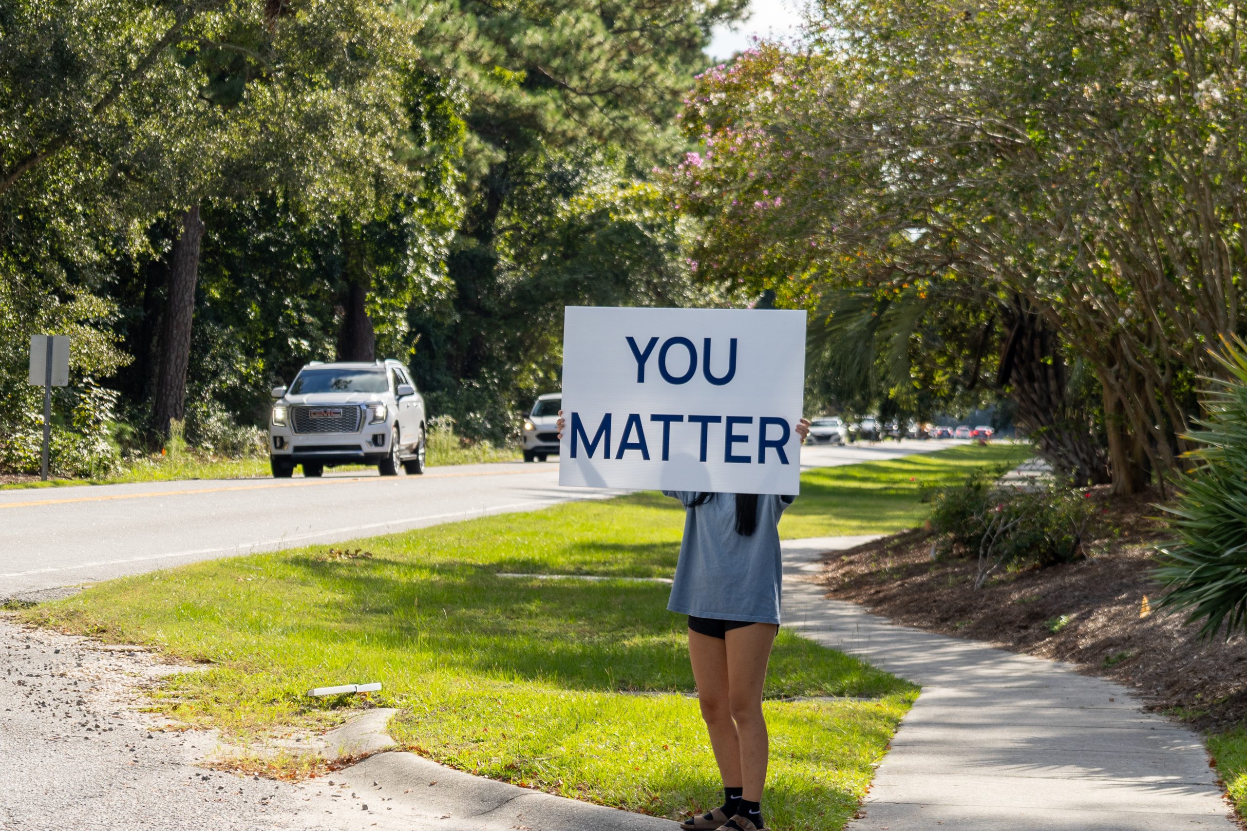 The girl behind the sign